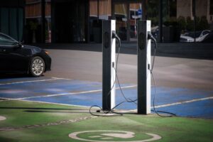 EV Charging points Close-up of an electric car charging station in the city against the backdrop of an office building, hotel or business center.