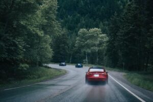 Tesla driving along woodland fast road